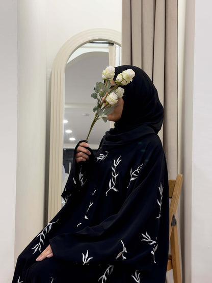 Korean nida abaya. Black abaya. Embroidered abaya. Black embroidered abaya. White embroidery. Abaya with white embroidery. Abaya with embroidery. Abaya with embroidery on sleeve. Koran nida embroidered abaya. Black abayas. Occasion abaya. Simple occasion abaya. 